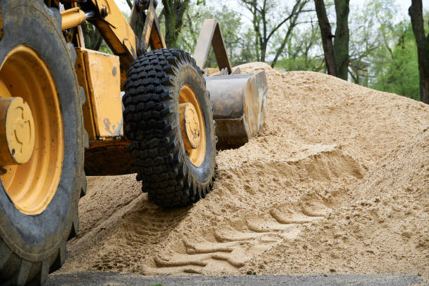 istock tractor or bulldozer works with a pile of sand for construction 1320926531