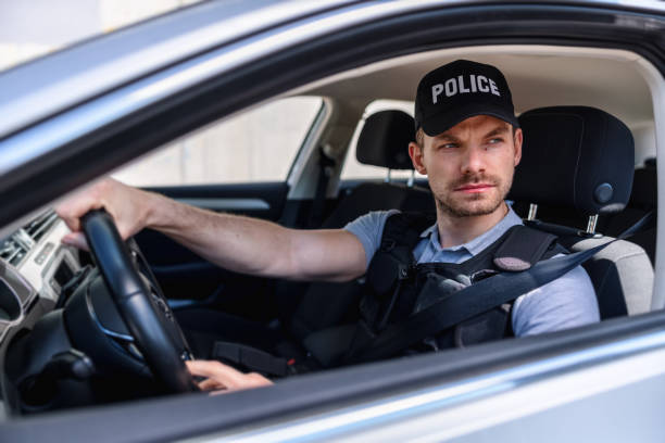 istock Policeman In Police Car 1320927339