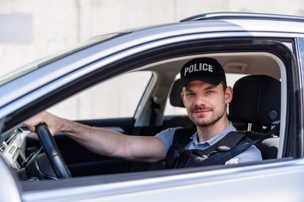 istock Policeman In Police Car 1320927475