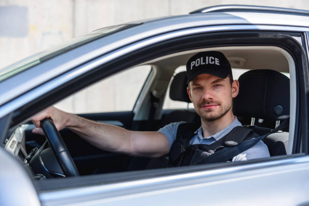 istock Policeman In Police Car 1320927476