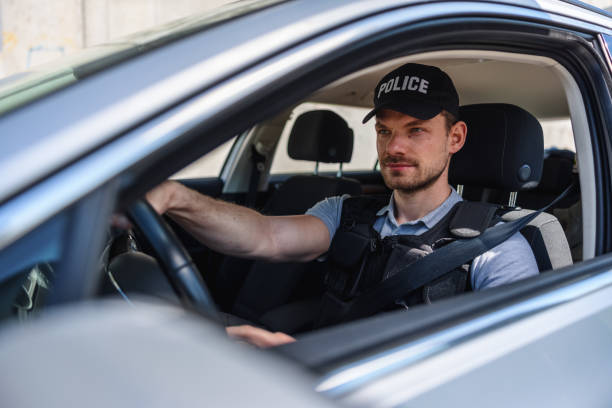 istock Policeman In Police Car 1320927478