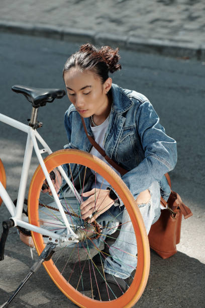 istock Vietnamese man finding out reason of bicycle breakdown 1320928690