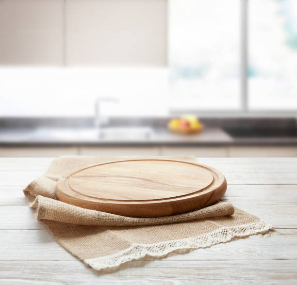 istock Napkin and board for pizza on wooden desk. Kitchen background. 1320928811