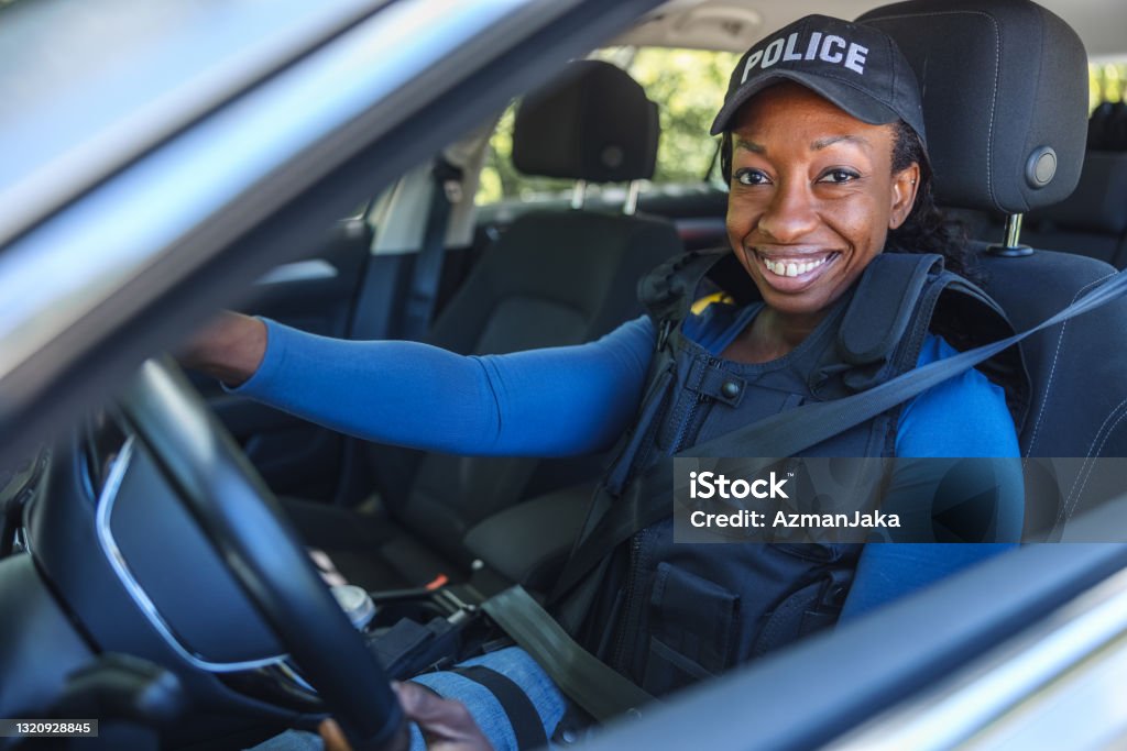 Policewoman Sitting In The Police Car And Looking At Camera Police Force Stock Photo