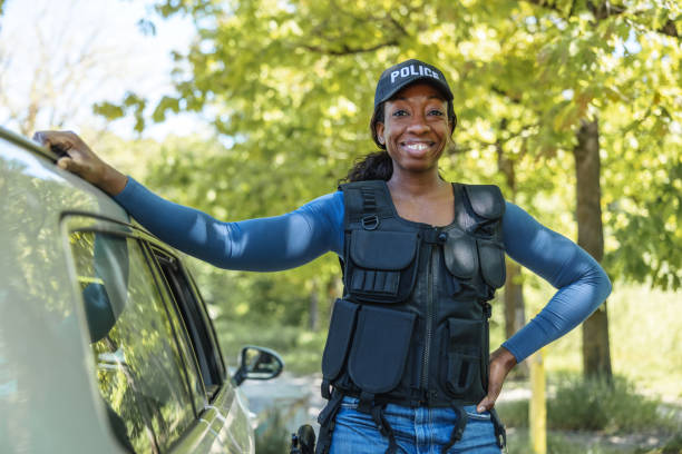 Policewoman Standing Next To Car And Smiling At Camera