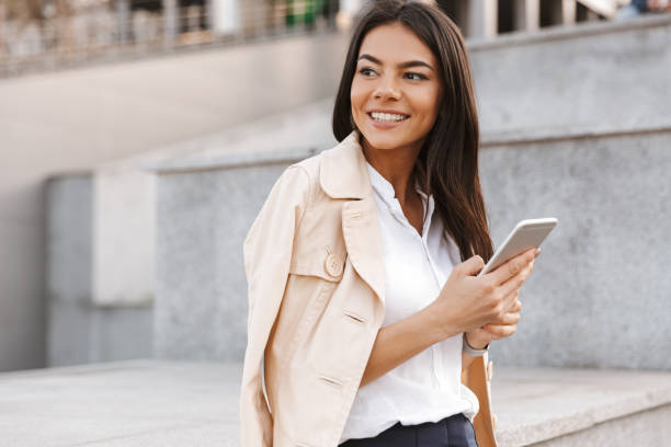 istock Happy young woman using mobile phone 1320929022