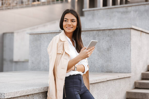 istock Lovely young woman using mobile phone 1320929480