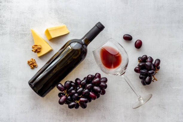 istock Red wine bottle with glass of wine and grape. Top view 1320930069
