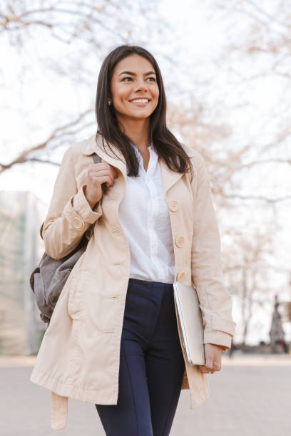 istock Happy young woman dressed in autumn coat 1320930131