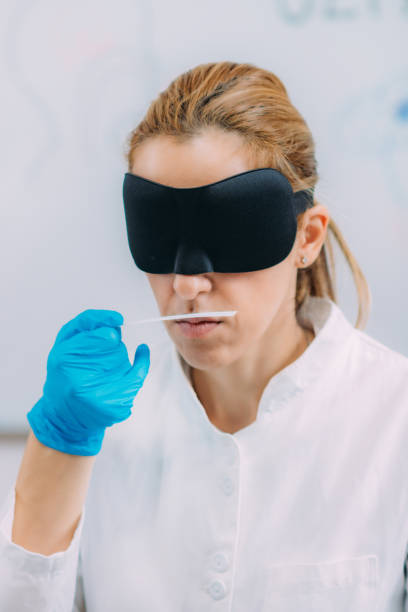 istock Olfaction. Female Scientist Examining Smells with Mask. 1320930202