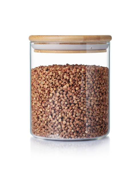istock Buckwheat in a glass jar isolated on a white background. 1320930268
