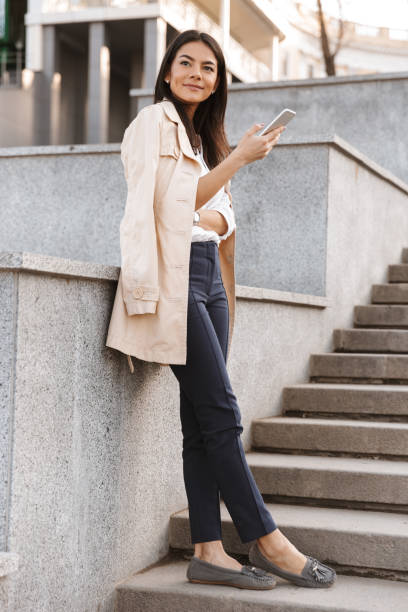 istock Pretty young woman using mobile phone 1320930320