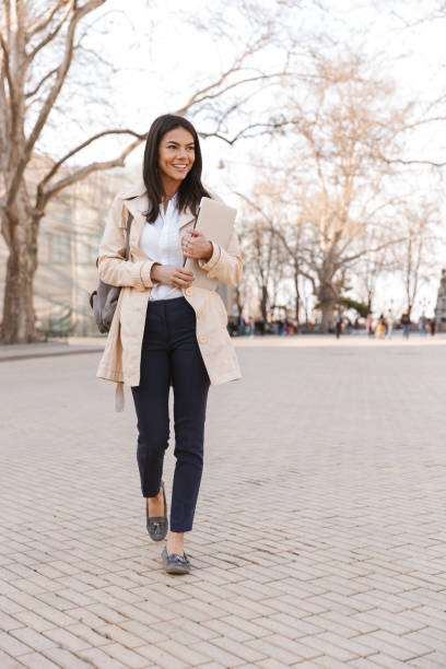 istock Smiling young woman dressed in autumn coat 1320930620