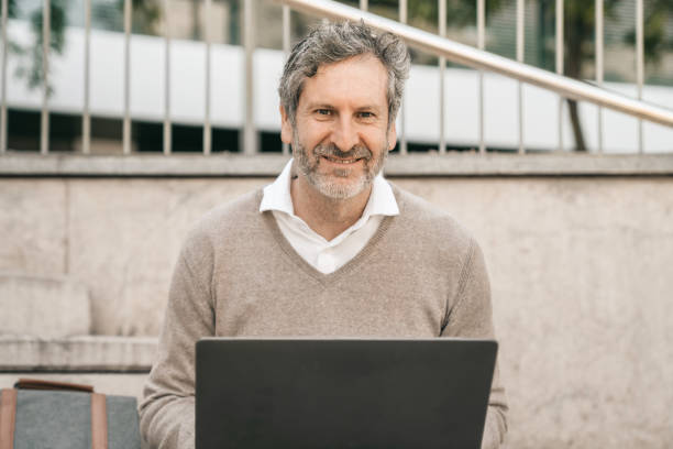 istock Teacher working on laptop on campus 1320930631