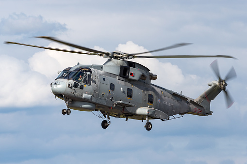 Gloucestershire, UK - July 14, 2014: Royal Navy AgustaWestland Merlin HM.2 Anti-Submarine Warfare Helicopter on approach to land at RAF Fairford.