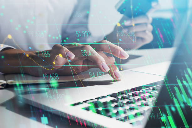 istock Office woman with device and graph stock market changes 1320931701