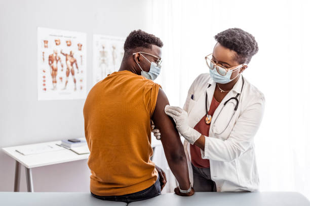 istock Healthcare Worker disinfect man arm before vaccination 1320931847