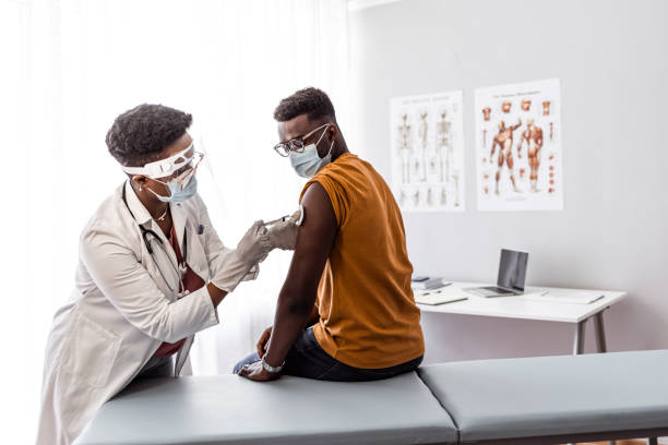 istock Man taking a vaccine from his doctor 1320931864