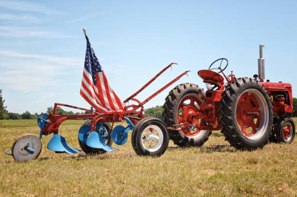 istock Small Town Rural USA Farm Tractor and Plow 1320933100