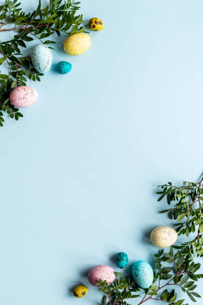 istock Easter eggs with spring branches and green leaves. Decoration concept, top view 1320933121