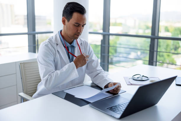 istock Mature Doctor Using Laptop In His Office 1320933900