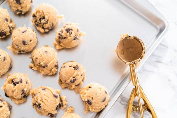 istock Homemade chocolate chip cookies dough scoops on a baking sheet. 1320933996