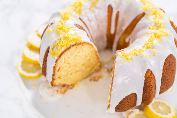 istock Sliced lemon bundt cake decorated with lemon zest on a cake stand. 1320934061