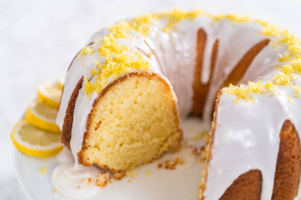 istock Sliced lemon bundt cake decorated with lemon zest on a cake stand. 1320934208