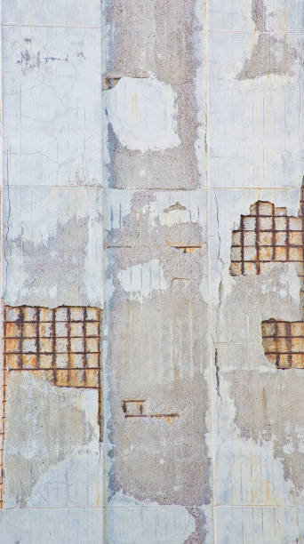 istock Old reinforced cracked concrete structure with damaged with rusty metallic reinforcement bars 1320937899