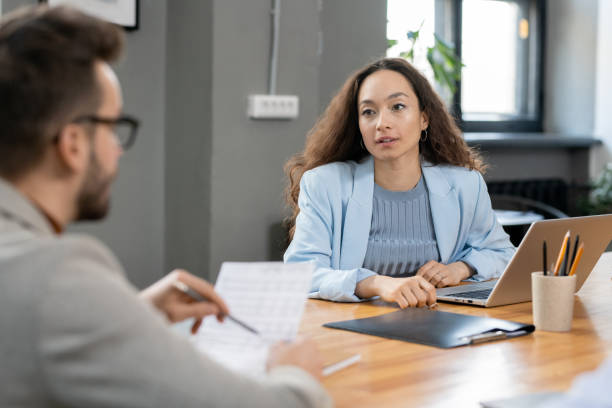 istock Elegant pretty financier talking to colleague 1320939933