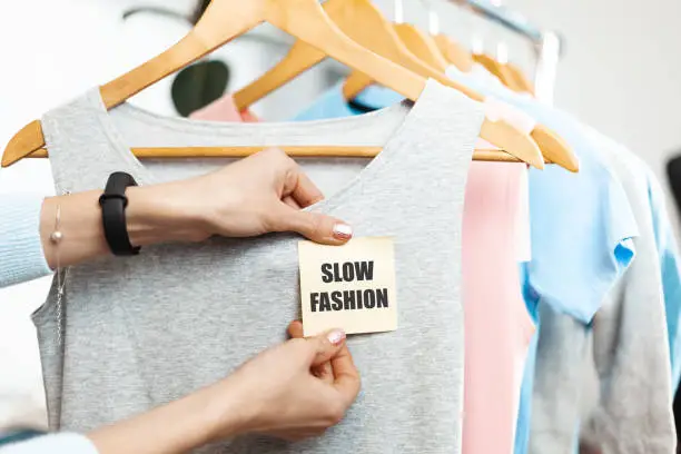 Slow fashion. Organic clothes on hangers in the store. Sustainable clothing production.