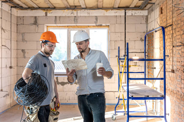 istock Two builders collaborate to build a new home. 1320941206