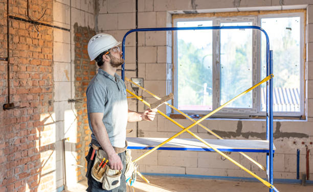 istock A handyman examines a drawing at a construction site. 1320941220