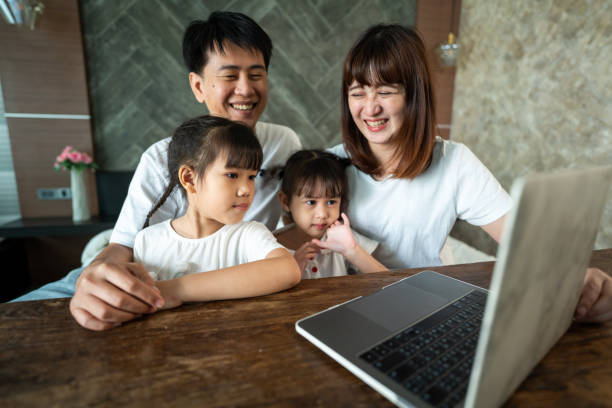 istock Social teleconferencing, Asian daughters and single mothers take online classes Via a computer with a wireless internet system. 1320942151
