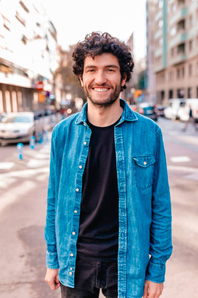 istock Curly haired brunet man on the street 1320942239