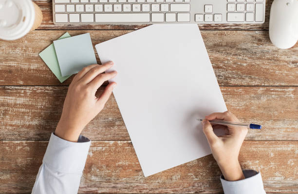 istock close up of hands with paper sheet and keyboard 1320942448