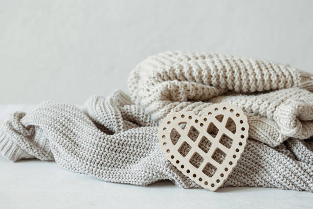 istock Cozy composition with knitted items and a wooden decorative heart. 1320943393