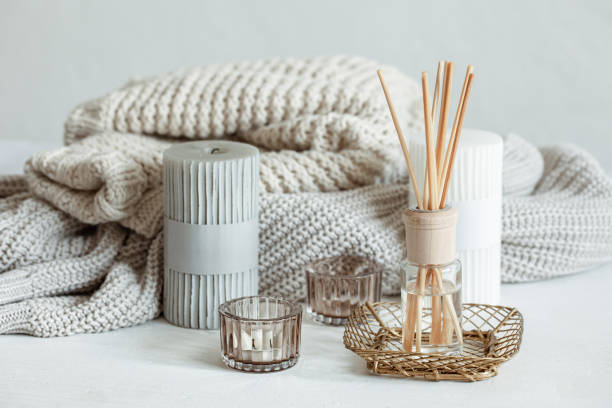 istock Cozy home composition with candles, aroma sticks and a knitted element. 1320943395