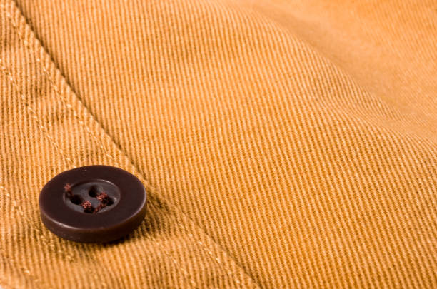 istock clothing items stonewashed cotton fabric texture with seams, clasps, buttons and rivets, macro 1320946039