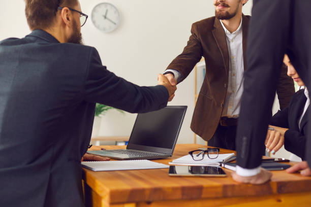 istock Young businesspeople making a deal and confirming collaboration with a handshake 1320946056