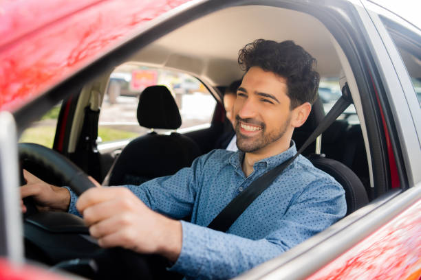 istock Taxi driver with passenger at back seat. 1320946421