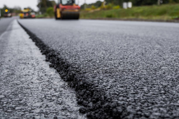 istock Asphalt road roller with heavy vibration roller compactor press new hot asphalt on the roadway on a road construction site. Heavy Vibration roller at asphalt pavement working. Repairing. 1320947842
