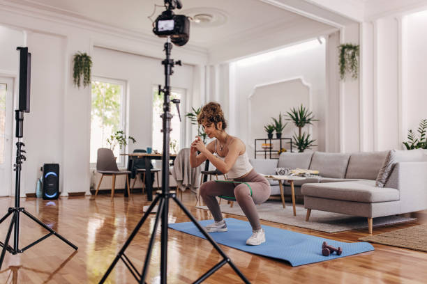 istock Fitness vlogger exercising at home 1320947986