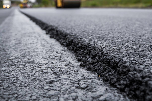 istock Asphalt road roller with heavy vibration roller compactor press new hot asphalt on the roadway on a road construction site. Heavy Vibration roller at asphalt pavement working. Repairing. 1320948544