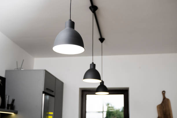 istock Industrial black look pendant lamps in a kitchen interior. Modern loft interior design. 1320948563