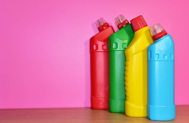 istock Detergent laundry bottles and sponge for washing on pink background 1320948940