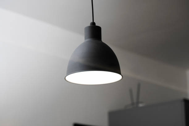 istock Industrial black look pendant lamps in a kitchen interior. Modern loft interior design. 1320949094