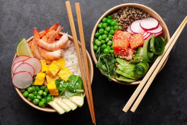 istock Poke bowls with shrimps, salmon, avocado and mango 1320950034