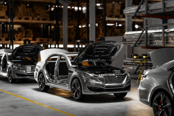 Cars on assembly line in plant