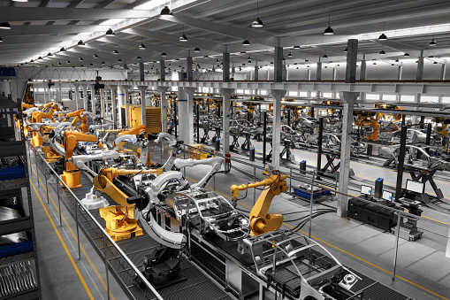 High angle view of cars on production line in factory. Many robottic arms doing welding on car metal body in manufacturing plant. Image in 3D render.